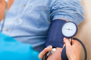 doctor checking blood pressure on patient