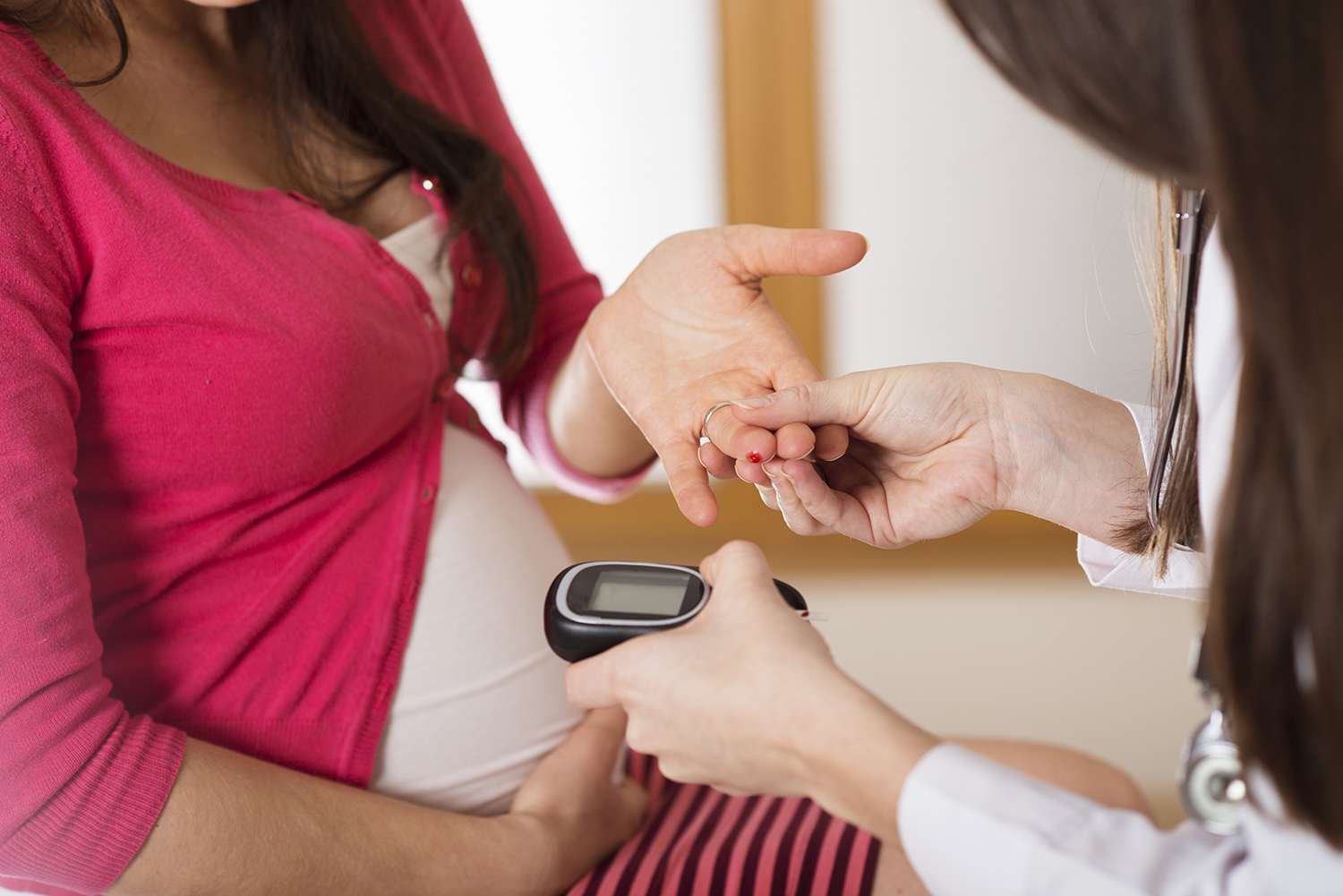Pregnant woman receiving a diabetes test