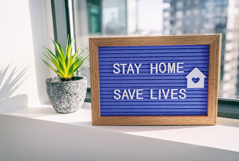 Stay Home Save Lives sign in window