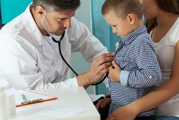 A doctor examining a boy