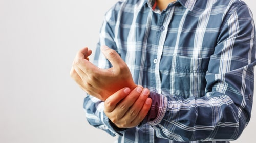 a person showing arthritis problems in his hand