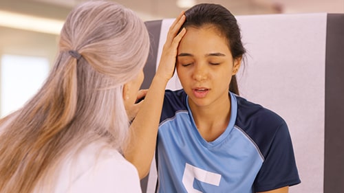a doctor examining a patient with concussion